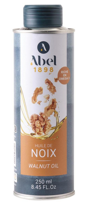 A 25 centiliter can of Abel 1898 walnut oil. The front of the can features a photo of walnuts riding on a wave of golden oil.