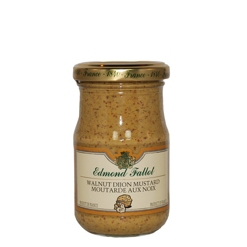 A 210 gram glass jar of walnut mustard from Edmond Fallot. The yellow mustard has moderate speckling from the walnut pieces.