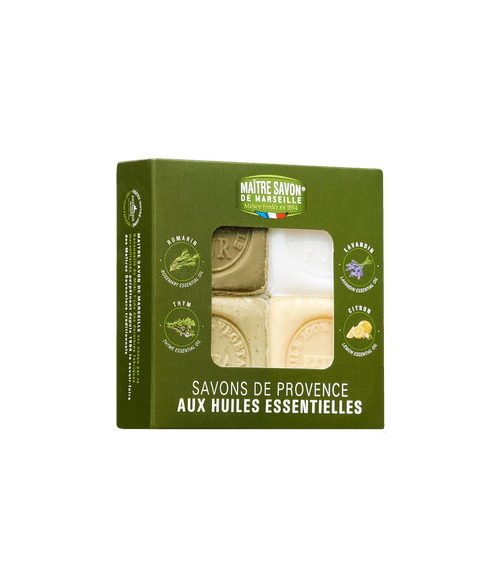 A box of four 125 gram Provence soap cubes with essential oils from Maître Savon de Marseille. The soap cubes are each a different color: white, cream, pastel green, and olive green.