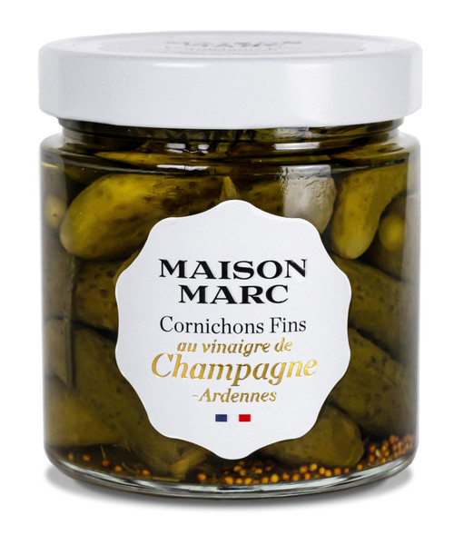 A 210 gram round glass jar of "cornichons fins," small gherkins, with Champagne vinegar from Maison Marc.