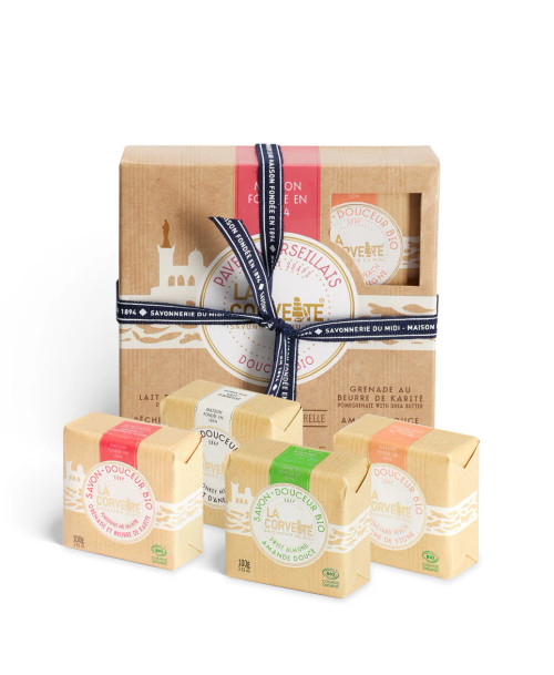 A box of assorted organic Marseille soaps from La Corvette, held together by a ribbon. In front of the box are the 4 100 gram cubes.