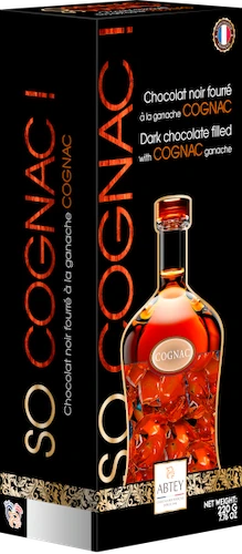 A box of 220 grams of "So Cognac" Abtey dark chocolates papillotes filled with Cognac ganache. The box is sleek and black, with a photo of a amber bottle of cognac next to a window that shows the chocolates wrapped in amber foil.
