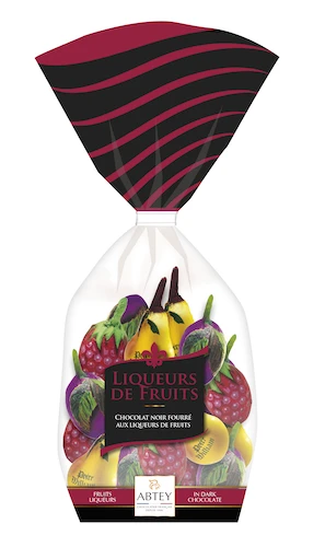 A clear bag holding 200 grams of assorted fruit-shaped dark chocolates with liqueur from Abtey. Each chocolate is covered in foil painted like the fruit, adding further detail.