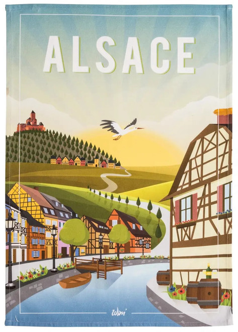 A tea towel from Coucke. The top of towel is titled "Alsace" in bold white text and depicts a canal cutting through a street. There is a farm in the background.