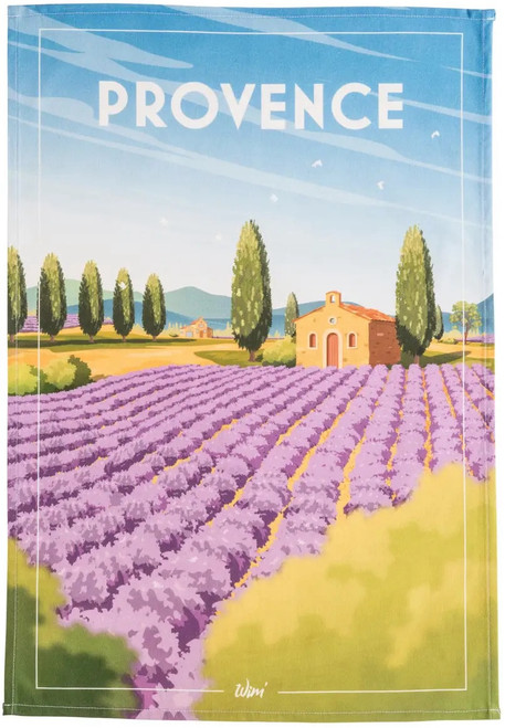 A tea towel from Coucke. The top of towel is titled "Provence" in bold white text and depicts a small brick house surrounded by a sprawling lavender field.