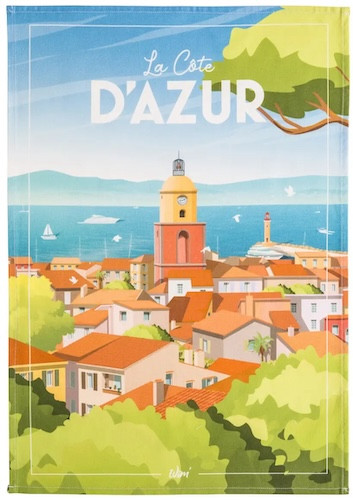 A tea towel from Coucke. The top of towel is titled "Côte d'Azur" in bold white text and depicts a vibrant coastal village with a prominent bell tower.
