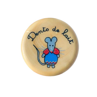 A wooden cylindrical box for holding a baby tooth, from Roger Orfèvre. The lid reads "dento de lait" and bears a drawing of a mouse in overalls.