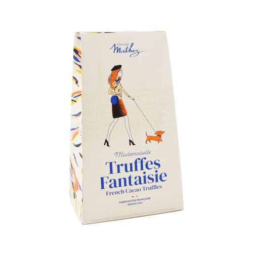 A tan box with blue and yellow piping, featuring an illustration of a lady in a beret walking a dog, containing 100 grams of cocoa-powdered truffles from Mathez.