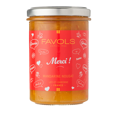A 250 gram jar of "Merci!" mandarin and nougat jam, from Favols. The jar's label is a bright red and reads, "Merci!" in a cursive font.