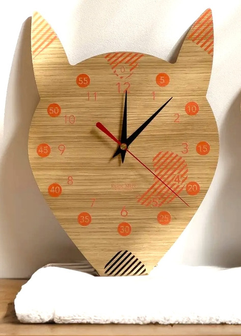 A fox educational clock, which features numbers 0-60 in increments of 5 alongside the traditional 12 numbers on a clock face. Made by Reine Mère.