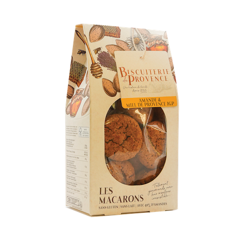 A 150 gram container of almond and honey macarons from Biscuiterie de Provence, with a clear center showing off the macarons directly.