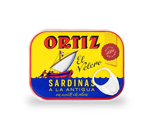 A 140 gram tin of Ortiz old style sardines in olive oil. The tin features a vintage style cartoon of a sailboat on the open sea.