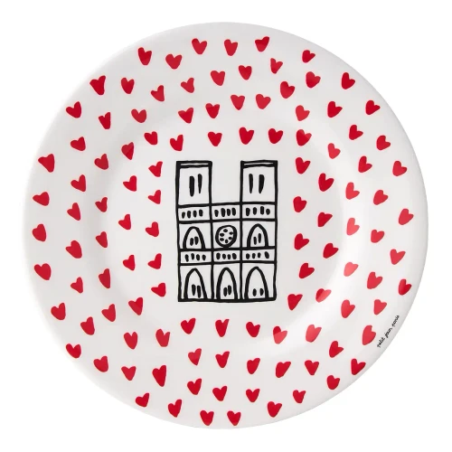 A dessert plate illustrated with the Notre-Dame cathedral surrounded by many small red hearts.