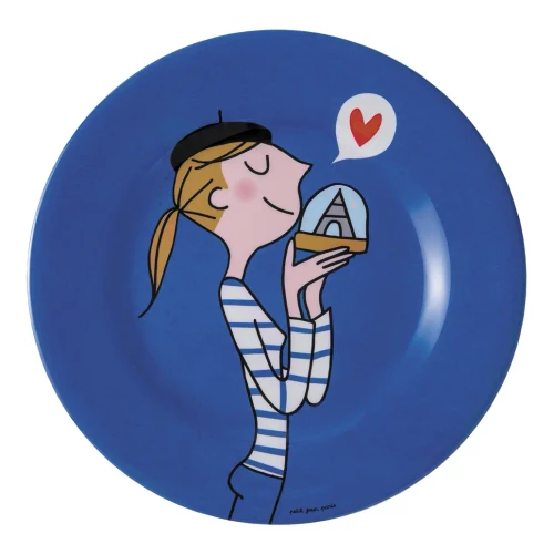 A blue dessert plate illustrated with a typical young Paris girl kissing an Eiffel Tower snow ball.