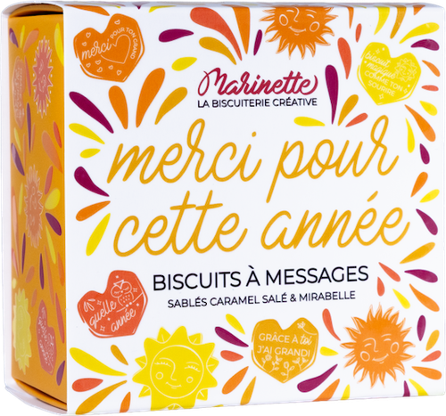 A 100g square box of Marinette heart-shaped shortbread cookies in orange and yellow hues, bearing the message "Merci pour cette année" (Thank you for this year).