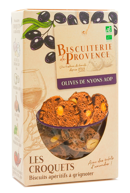 A 90 gram box of organic croquets with Nyons olives from Biscuiterie de Provence. The crisp, thin crackers with almond pieces are visible through the box's window.