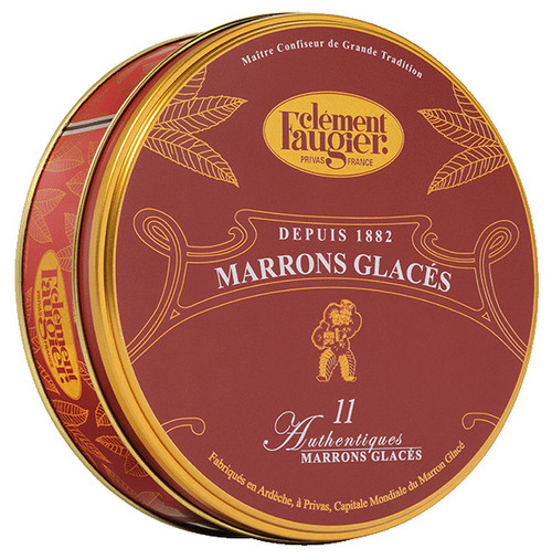 A 260 gram tin of marrons glacés, or candied chestnuts, from Clément Faugier. The red circular tin has gold accents of leaves on the side.