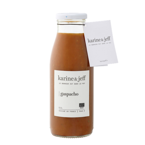 A 50 centiliter glass jar of organic gazpacho from Karine & Jeff. The red soup is well blended and opaque.