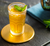 A glass of Lipton tea on a coaster.