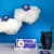 A box of Les 2 Marmottes "fée nuit" herbal tea surrounded by clouds. The clouds are lifting individual packets of the tea into the sky.