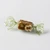 A single piece of hazelnuts caramels from Mon Pari Gourmand. The caramel is square and wrapped in transparent yellow foil.