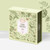 A magnetic-clasp case containing 20 sachets of Provence d'Antan organic digestive herbal tea, a blend of lemon verbena, lemon balm, and linden. The case is a light green and the border features sketches of grass, flowers, fruit, and insects. The case sits on a table with a yellow background.