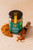 A jar containing 40 grams of an aromatic herb blend well suited for ratatouille from Comptoir & Co. The jar sits on a stone surface next to a scoop.