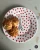 A dessert plate illustrated with the Eiffel Tower surrounded by many small red hearts, with chouquettes (French pastries) on the plate.