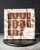 A 190 gram box of marshmallows covered in milk and dark chocolate, shaped into bears. From Le Chocolatier Sablais. The box is on a wooden coaster on a stone countertop.