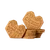 Two Marinette heart-shaped shortbread cookies bearing messages for grandmother on top and next to a pile of cookies.