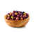 A wooden bowl containing 230 grams of Niçcoise olives from Barral. The olives are purple.
