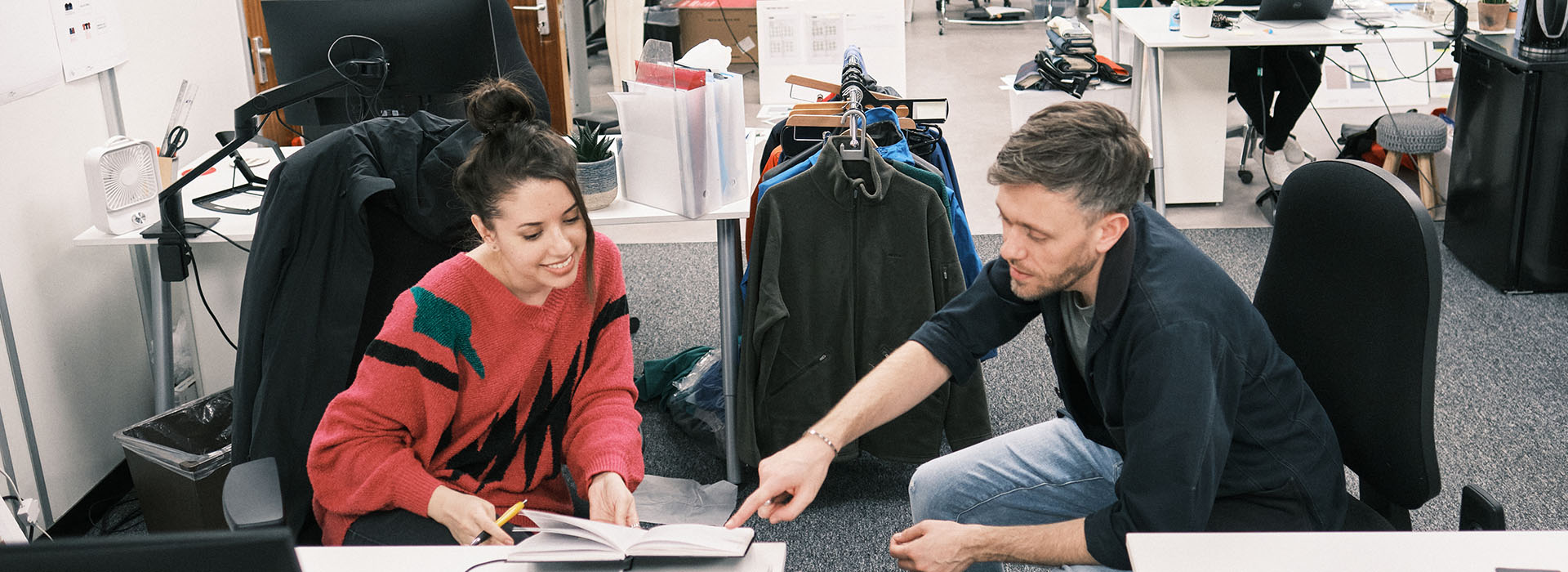 Design team members looking at a sketchbook