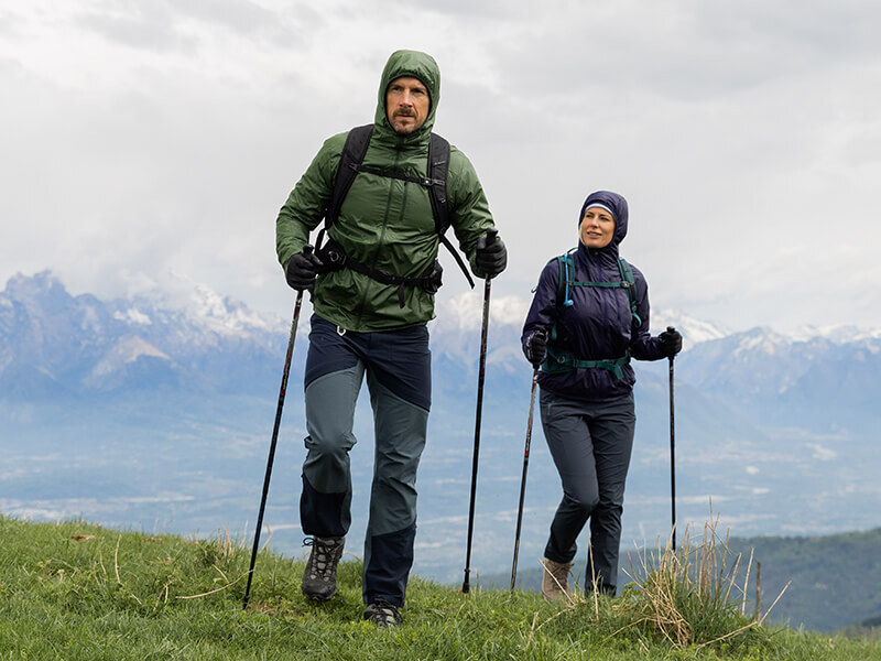 Man and Woman Wearing Bora Jackets Hiking  on a Mountain