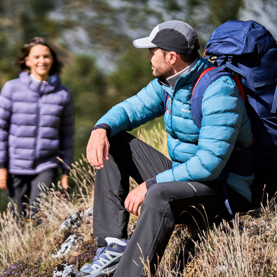 Man and Woman wearing Winter Walking Kit, including Insulated Jackets, Walking Trousers, Hats and Gloves.