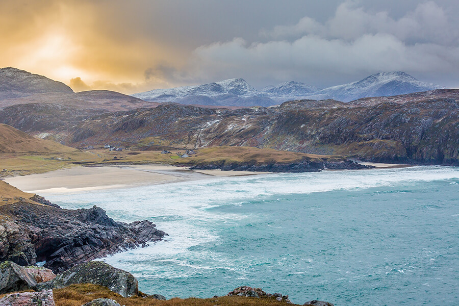 Rugged Snowy Mountains Behind a Sandy Beach in the Isle of Lewis
