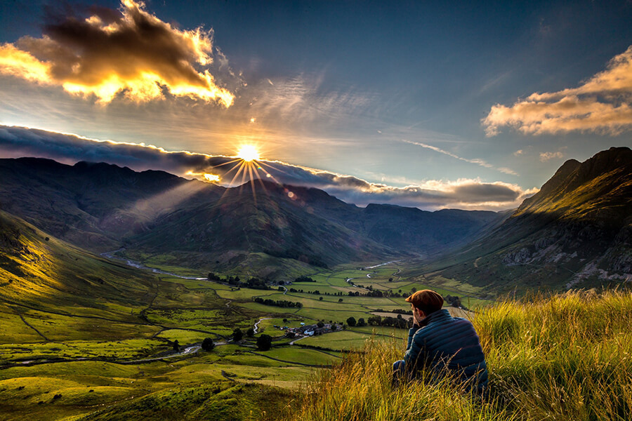 Chris Orange Taking a Photograph in Mountain Valley with Sunset in Little Langdale
