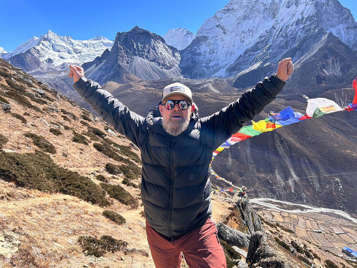 A loyal customer, John, hiking a mountain, wearing Rohan gear