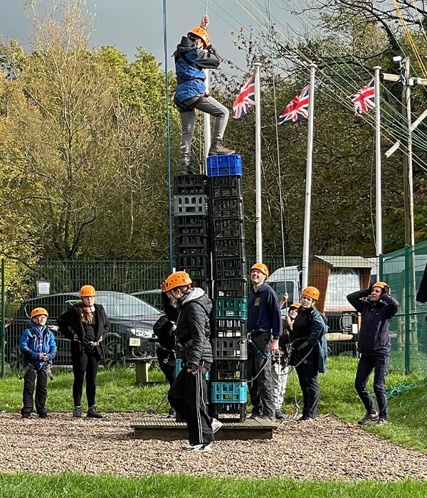 Participants of 1st Wythenshawe Scout Group crate stacking whilst on their scout camp