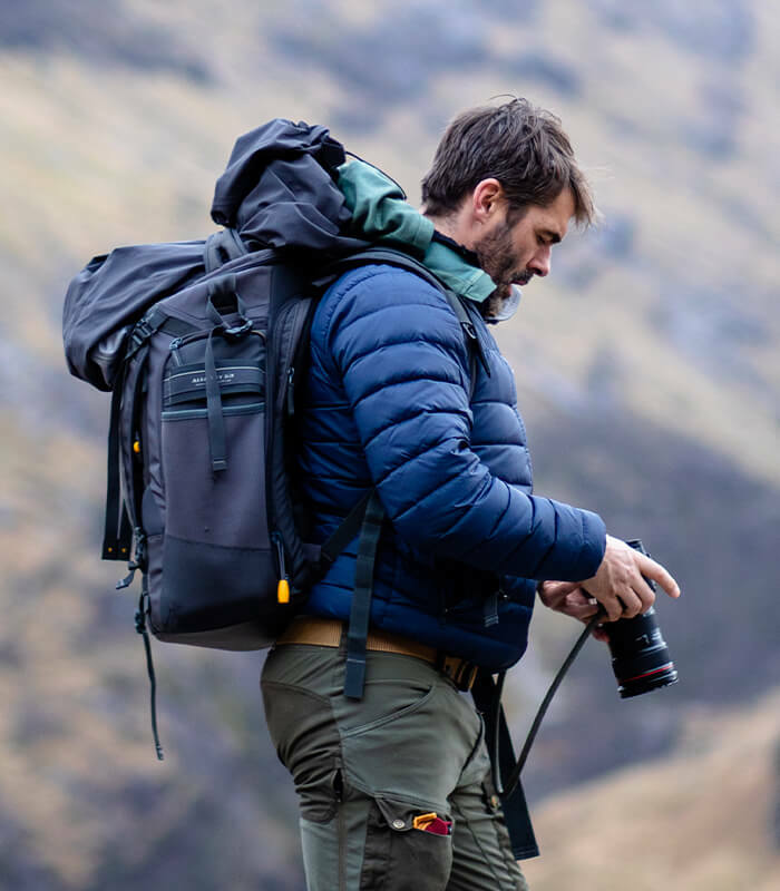 Ian Finch Photographer Checking Camera in Scottish Landscape
