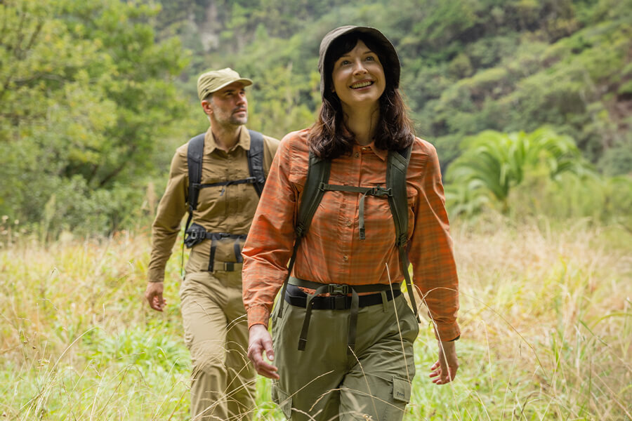 Man and Woman in Wild Grass Wearing Insect Repellent Clothing