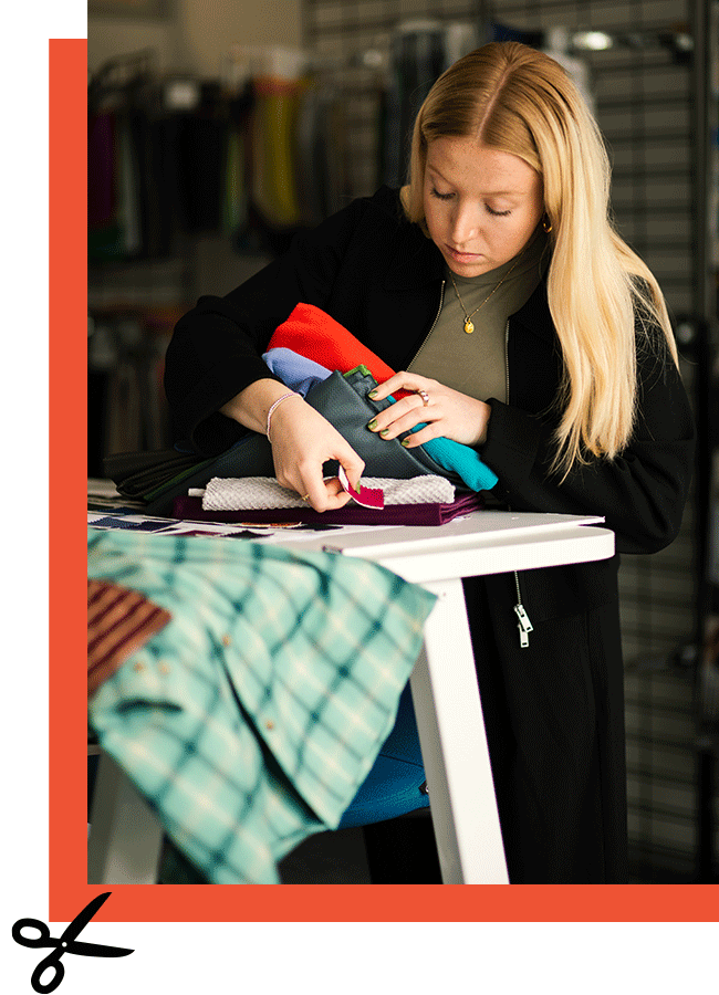 Rohan Colour Specialist Jodie Sandham in the design studio, comparing coloured fabrics.