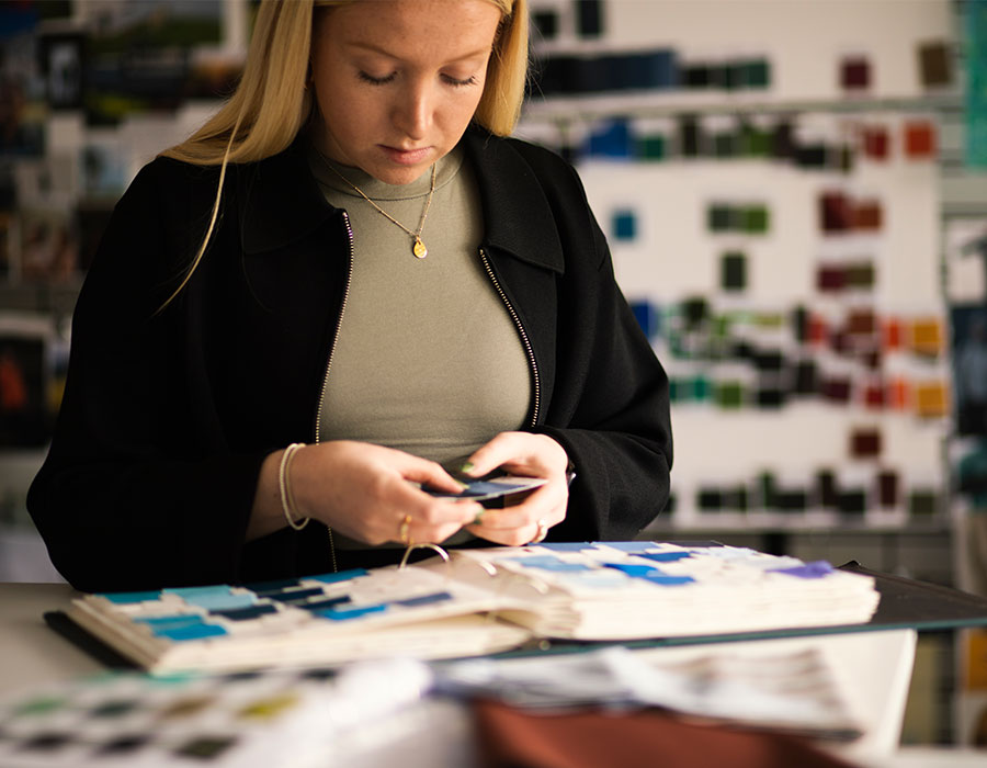 Rohan Colour Specialist Jodie Sandham in the design studio, comparing colour swatches