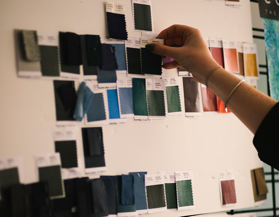 Rohan Colour Specialist Jodie Sandham in the design studio, comparing colour swatches