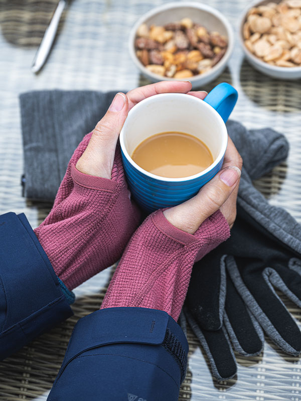 Woman holding a cup of tea on a winter walk