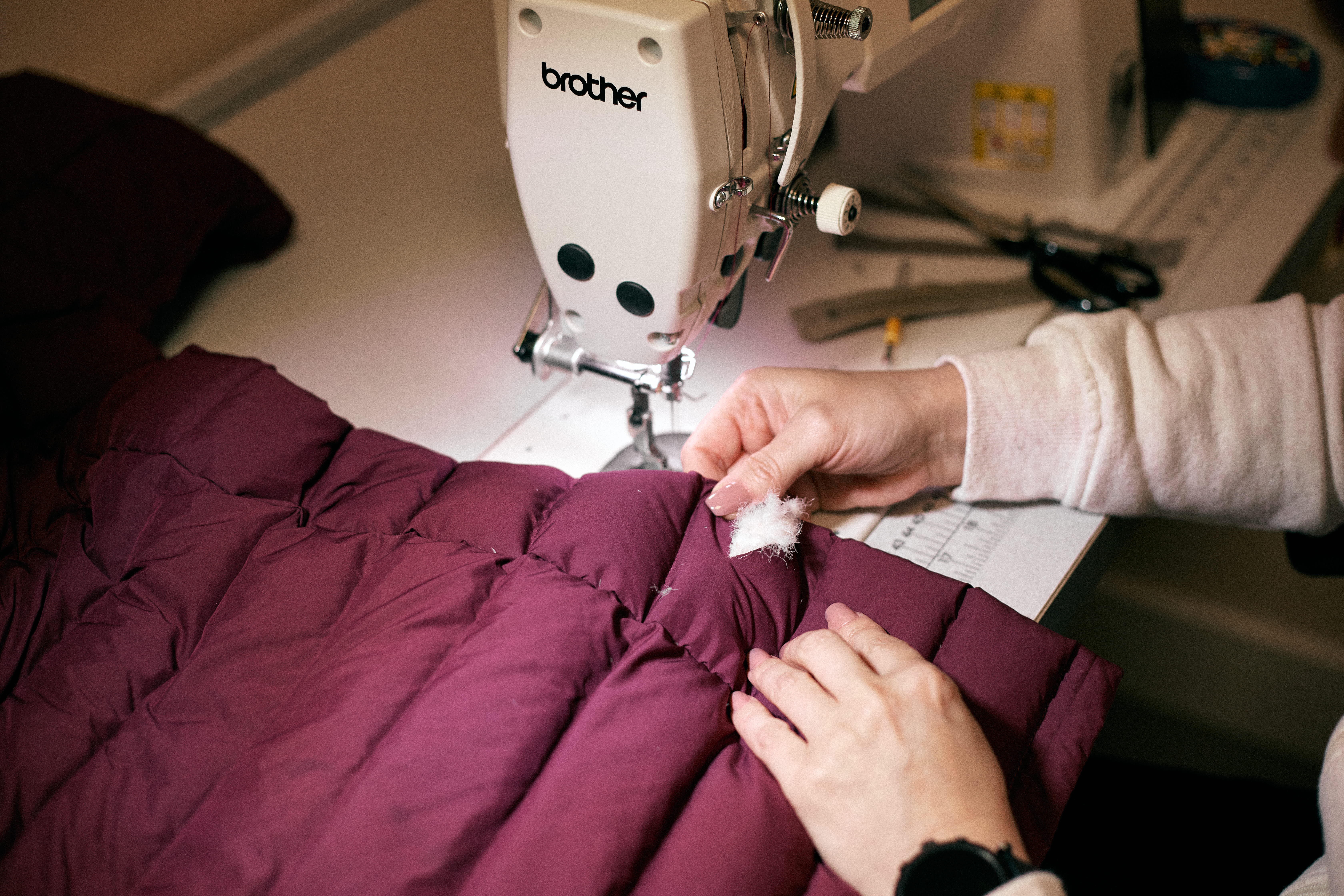 A sewing machine in the Rohan repair shop, fixing an insulated jacket.