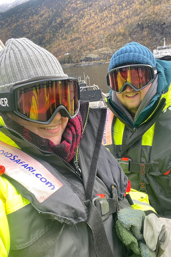 Connie and Ben wearing multiple layers and thermal overalls and goggles ready for the RIB-Boat Tour on Aurlandsfjord