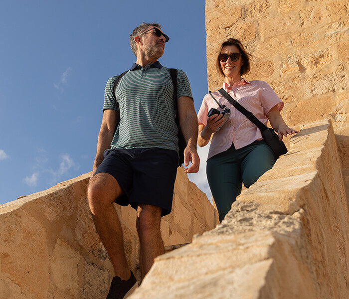 Man and Woman Cycling in UV Protective Clothing