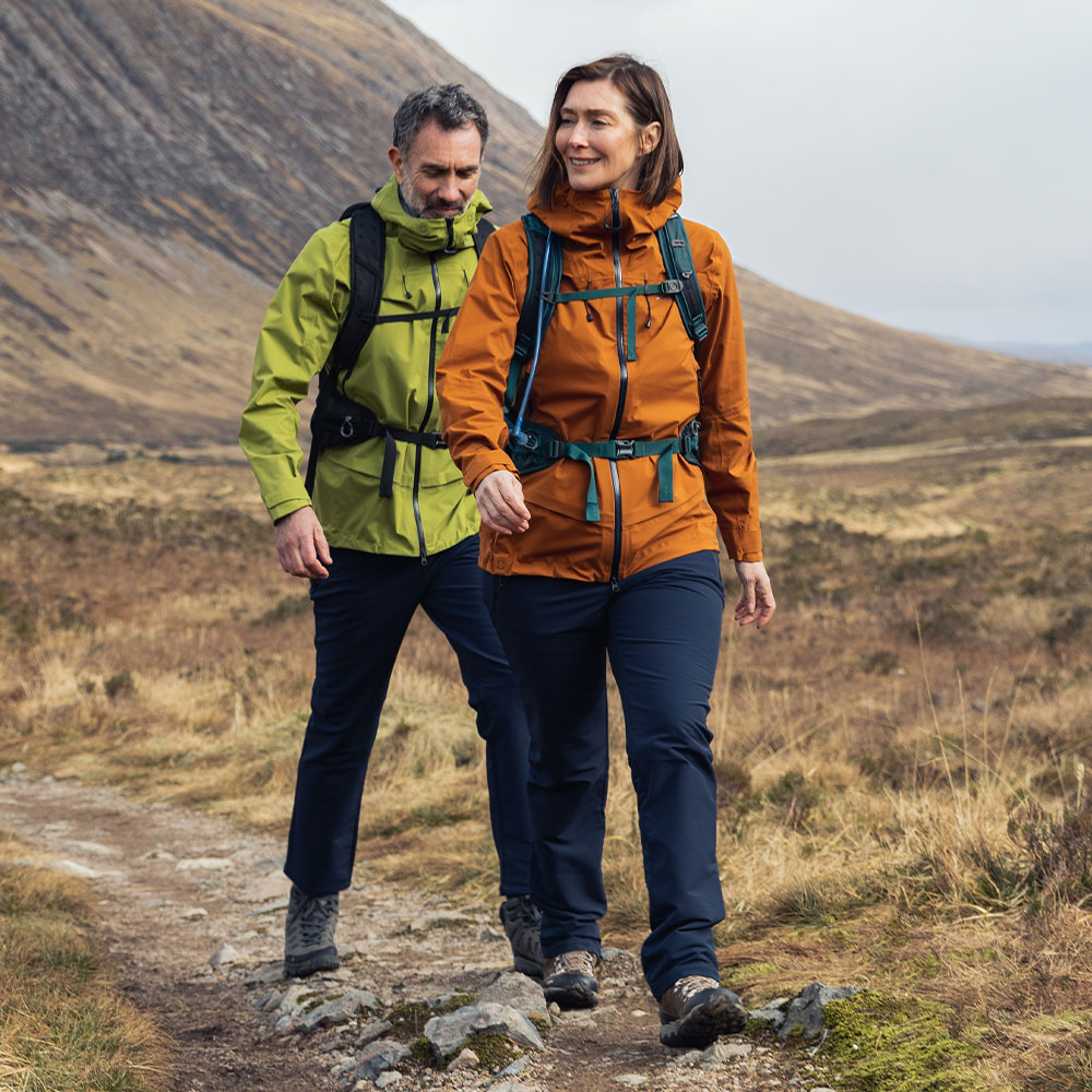 Man and Woman wearing Rohan Walking Trousers whilst walking in the countryside