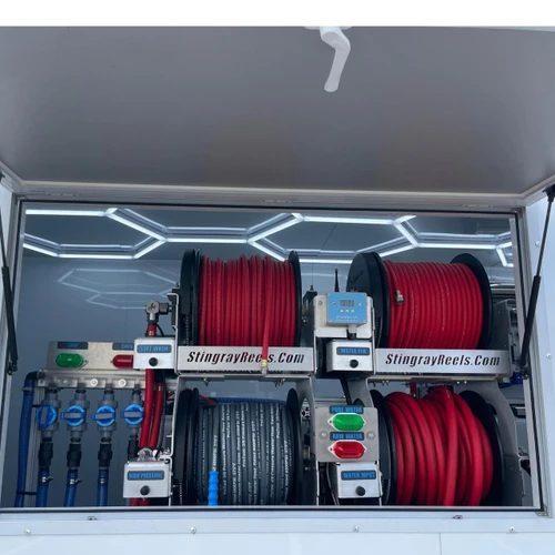 ProTool Enclosed Drone Trailer - V-SPEC, open side compartment displaying organized red and black hose reels, water controls, and illuminated interior storage.