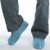 J.Racenstein Shoecover Skid Resistant, pair of blue skid-resistant shoe covers worn over regular shoes by a person standing on a smooth surface.